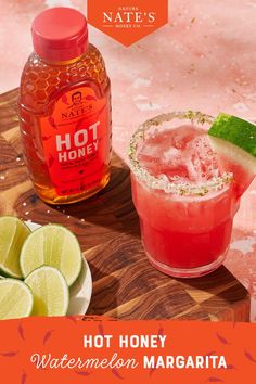 a bottle of hot honey watermelon margarita next to a drink