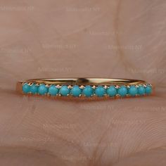 The ring made with Genuine Turquoise Gemstone and 14K solid yellow gold Dainty Wedding Band Ring * SKU: SGR00452 * Made to Order. * Gold Purity: 14K Solid Yellow Gold (stamped) * Custom Gold Color: Yellow, Rose, White Gold * Custom Gold Purity: 9K/14K/18K (Charges Apply) * Genuine Turquoise Gemstone Weight: 0.25 ct. Product Measurements:- Ring Size: 2 to 10 (All sizes available) ✦ Size can be customized as per your request, please mention the required size in buyer notes (Charges may apply). ✦ S Dainty Wedding Band, Eternity Band Ring, Half Eternity Band, Band Engagement Ring, Engagement Bands, Genuine Turquoise, Fine Jewelry Gift, Sapphire Gemstone, Turquoise Gemstone