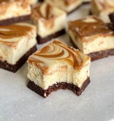 several pieces of dessert sitting on top of a white plate with caramel swirl toppings