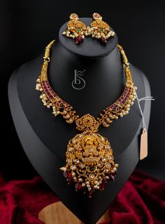 Kanti Nakshi collection Necklace with earrings in Ruby, jadau kundan and CZ, AD stones embossed along with ruby color beads. This necklace comes with matching earrings jumkas of perfect size. Heavy Temple Jewelry Set In 22k Gold, Designer Stone Work Jhumkas For Festive Occasions, Heavy 22k Gold Temple Jewelry Set, Kundan Jhumkas For Festivals, Designer Chandbali Jhumkas With Stone Work, Designer Stone Work Jhumkas For Festivals, Designer Festival Jhumkas With Stone Work, Festival Designer Jhumkas With Stone Work, Designer Gold Chandbalis With Stone Work