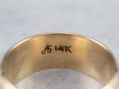 This wide vintage band is crafted entirely of 14k yellow gold. The center of this ring is slightly domed, giving it the ability to catch the light, and is accented by the masculine carvings on the edge. Metal: 14K Yellow Gold Width of Band: 7.8 mm Height off Finger: 1.5 mm Ring Size: 6 Marks: "A14K" Stamped on the inside band Vintage Band, Eternity Bands, Gold Bands, Cuff Bracelets, Ring Size, Yellow Gold, Carving, Band, Gold