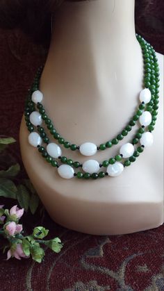 "Three strand Semi-precious stone designer necklace made with faceted jade 4 mm and faceted cut artist milk glass beads. The lenght of this gorgeous necklace is 18\" long. Looks great with lots of outfits. If you like it \" pin it \" or share on Facebook." Elegant Faceted Jade Beaded Necklaces, Elegant Faceted Jade Beaded Necklace, White Jade Beaded Necklaces With Round Beads, White Jade Beaded Necklace With Gemstone Beads, Faceted Jade Round Bead Necklace, White Faceted Round Beads Necklace, White Double Strand Faceted Beads Necklace, Wooden Bead Jewelry, Rhodochrosite Necklace