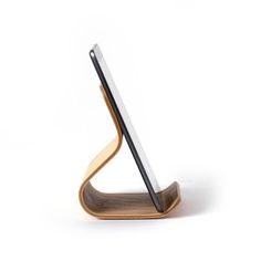 a wooden tablet stand with a laptop on it's side and a white background