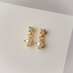 Crafted with 14k gold plating and a sterling silver base, these earrings feel as good as they look. Whether you're dressing up for a special occasion or simply accenting your everyday look, these earrings are a must-have addition to your jewelry collection. Height: 10mm Dainty Gold-plated Pearl Earrings For Pierced Ears, Dainty Gold Plated Pearl Earrings, Delicate Gold Hypoallergenic Earrings, Delicate Hypoallergenic Gold Earrings, 14k Gold Dangle Bridal Earrings As Gift, Delicate Pearl Earrings With Cubic Zirconia For Gift, Hypoallergenic Gold Plated Earrings For Anniversary, Delicate Cubic Zirconia Pearl Earrings For Gift, Dainty White Gold Plated Earrings