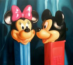 two mickey and minnie mouse heads on top of each other