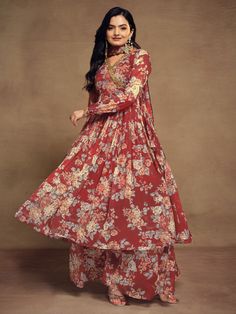 Indulge in the timeless allure of our ravishing red chiffon suit, adorned with exquisite floral print, zari work, and sequin detailing. This ensemble encapsulates the essence of elegance and sophistication, with its vibrant red hue and delicate embellishments. Crafted from high-quality chiffon material, it offers a luxurious feel and a flattering drape, ensuring both comfort and style.
Accompanying this stunning suit is a matching chiffon palazzo, intricately designed with floral print work to c Wedding Palazzo Set In Georgette With Printed Motifs, Wedding Sharara With Printed Motifs In Georgette, Wedding Sharara With Printed Motifs, Fitted Red Palazzo Set With Sheer Dupatta, Bollywood Floral Print Georgette Palazzo Set, Bollywood Style Floral Print Palazzo Set In Georgette, Floral Print Long Sleeve Salwar Kameez For Wedding, Festive Floral Print Anarkali Set For Party, Elegant Floral Print Palazzo Set For Party