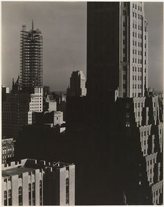 black and white photograph of skyscrapers in new york city, from the empire building