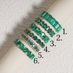 Crafted to perfection, our Lab Grown Emerald Eternity Bands stand out as stunning pieces of elegance. Encased in a fine Gold Band, each ring features a mesmerizing Green Emerald at its center, exuding a sense of sophistication and charm. These Stackable Rings offer versatility, allowing you to mix and match for a personalized touch, perfect for daily wear or special occasions. Whether worn alone or as part of a bridal jewelry set, these bands add a touch of luxury to any ensemble. Elevate your s Luxury Channel Set Emerald Engagement Ring, Luxury Green Eternity Band For Anniversary, Emerald Stackable Ring, Emerald And Diamond Eternity Band, Emerald Anniversary Ring, Emerald Infinity Band, Emerald Stone Wedding Band, Green Emerald Eternity Band, Emerald Green Wedding Band