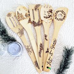 six wooden spoons with christmas designs on them