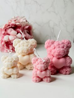 crocheted teddy bears are sitting next to each other on a white countertop