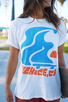 Our hometown - Venice, CA! Flowy skater design mixed and bright colors embodies Venice essence! The tee is the softest, most cozy shirt -- with a vintage wash, it looks like you grabbed it straight from your cool aunts 70s wardrobe. Our limited edition Junk Food Clothing Tee Shirt Collab is here! Now your favorite soft tees come in your favorite GRLSWIRL style. Casual Relaxed Fit T-shirt With Retro Print, White Retro Print T-shirt For Streetwear, Retro Tri-blend T-shirt For Streetwear, Casual Pre-shrunk Surfing T-shirt, Tri-blend Retro T-shirt For Streetwear, Summer Retro Print Tops For Streetwear, Casual Pre-shrunk T-shirt For Surfing, Casual Screen Print Top For Surfing, Retro Cotton T-shirt For Surfing