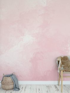 a chair sitting in front of a pink wall with a cow skin rug on the floor