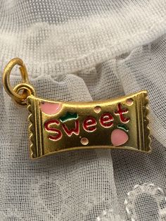 SUPER SWEET CHARM! This cute little charm or pendant would be great for a charm necklace! Fun strawberry candy charm! Both sides designed.  New and unworn. Matte gold tone with enamel. Jump ring included. Please refer to pic with ruler for measurements in inches. Cheap Retro Necklaces With Vintage Charm, Cute Charms With Lobster Clasp For Gift, Cute Gold Charms For Gifts, Cute Pendant Charms For Gifts, Personalized Cute Charms For Birthday, Cute Personalized Birthday Charms, Cute Charm Necklaces For Valentine's Day, Cute Charms For Valentine's Day Gift, Cute Valentine's Day Gift Charms