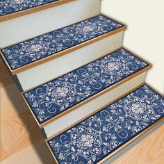 a set of stairs with blue and white designs on the treads in front of wood flooring