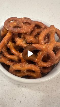 a bowl filled with pretzels sitting on top of a counter