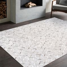 a living room with a fireplace and white rug