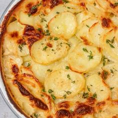 a close up of a pizza with potatoes and herbs on it's toppings