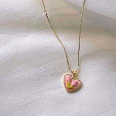 Trendy Pink tulip flower heart shaped pendant charm necklace, 14K real gold plated chain. Crafted from high-quality materials, this stunning necklace features a delicate heart-shaped pendant adorned with a beautiful pink tulip motif, symbolizing love, beauty, and new beginnings. Cute girly aesthetic, y2k layering necklace choker. Exquisite statement necklace to elevate your fashion style. 💎 Features: ♥ Handmade jewelry ♥ Finish Tone: Finest 14K gold plated | Pink ♥ Approximate Measurements: - Length: 18" with 2" adjustable - Pendant Width: 0.5" ♥ Nickel/Lead Free, Hypoallergenic, good for sensitive skins 🎁 Packing & Shipping: ♥ All our jewelry will be shipped with beautiful gift wrap packaging ♥ Handwrite gift notes/cards available upon request ♥ SAME DAY& FREE US Domestic Shipping avail Cheap Pink Heart Charm Necklace, Cute Girly Aesthetic, Y2k Layering, Handwritten Gifts, Wrap Packaging, Heart Shaped Pendant, Girly Aesthetic, Layered Chokers, Tulip Flower