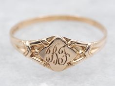 This exquisite ring features a tasteful "BF" engraving, adding a touch of sophistication and exclusivity to your look. Made with yellow gold, this ring is the perfect accessory for those who appreciate the finer things in life! Metal: 10K Yellow Gold Top Measurements: 5.0 mm, Diamond Shaped Monogram: "BF" Engraved Ring Size: 1.50 Marks: "()10K" Stamped on the inside band SKU #: A49943 Each piece has been identified and graded by a Graduate Gemologist who has been certified by the Gemological Institute of America (GIA). We have six brick-and-mortar storefronts in Maine, Massachusetts, and New Hampshire and have been in business for over 25 years! Please visit our Shop's About Page or our website for more information about our jewelry. For questions about diamond grading, we recommend the  G Heirloom Engraved Ring With Intricate Design, Engraved Vintage Stackable Promise Rings, Heirloom Engraved Yellow Gold Stackable Rings, Heirloom Yellow Gold Engraved Stackable Rings, Engraved Oval Signet Ring For Promise, Intricate Engraved Promise Ring, Heirloom Engraved Promise Ring With Intricate Design, Vintage Promise Rings With Engraving Option, Classic Engraved Promise Ring With Intricate Design