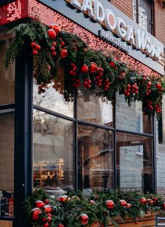 christmas decorations adorn the windows of a restaurant