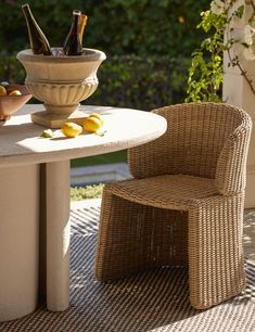 an outdoor table with two chairs and bottles on it