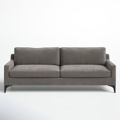 a gray couch sitting on top of a white floor