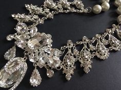 "Perfect for all bridal or party to wear!! Victorian shaped necklace featuring sparkle pendant set in center and linked to pearls chain on both sides. Color: clear rhinestone crystals, glass stones and pearls Size: necklace measures around 19.25\" long x center sparkle 4\" x 3\" Item ship out with tracking number to you (around 10 to 14 business days for delivery). We also provide fast shipping service, around 3-4 business days delivery but need to add extra charge. Please convo us if need." Glamorous White Jewelry For Wedding, Glamorous White Wedding Jewelry, Glamorous Elegant Jewelry Sets For Wedding, White Sparkling Rhinestone Necklace For Wedding, Sparkling White Rhinestone Necklace For Wedding, Glamorous Bridal Necklace With Elegant Design, Glamorous Bridal Necklace With Elegant Design For Wedding, Glamorous Wedding Jewelry, Wedding Necklaces With Cubic Zirconia Bling