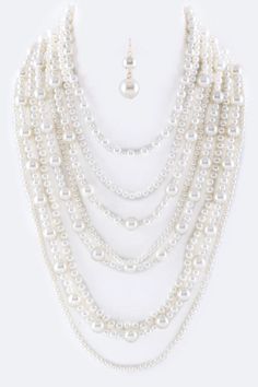 Enhance your everyday look with the stunning Million Pearls Layer Necklace Set. With layers of lustrous pearls, this set adds elegance and sophistication to any outfit. The perfect accessory for a night out or a special occasion. Elevate your style and make a statement with this beautiful necklace set. SPECIFICATIONS: Necklace - 17" + Extension Earrings - 1.85" Drop Lead & Nickel Compliant Chic Pearl White Necklace For Party, Chic Pearl Drop Necklace For Party, Chic Pearl White Pearl Necklace For Party, Classic Pearl Necklace For Party, Classic Pearl Necklace With Pearl Chain For Parties, Classic Pearl Drop Necklaces For Party, Classic Pearl Drop Necklace For Party, Multi-strand Pearl Drop Necklaces For Party, Elegant White Pearl Layered Necklace