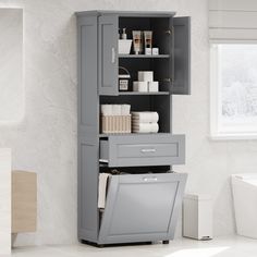 a bathroom cabinet with drawers and towels on it's sides, in front of a white wall