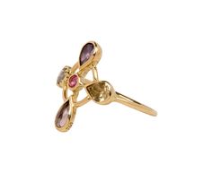 Bold and elegant, this one-of-a-kind Dorette ring is a dance of vibrant stones surrounding a tiny pink spinel. The pink sapphire, light tourmaline, purple tourmaline and diamond are hand set in 18K yellow gold bezels backed with sterling silver to create the four surrounding petals of the flower. Playfully sophisticated and ultra-feminine, this eye-catching ring adds an effortless style to any jewelry collection. ring face : 3/4" x 3/4"light tourmaline : .26ctpurple tourmaline : .28ctpink sapphi Yellow Gold Rings With Pink Sapphire And Gemstone Accents, Gold Multi-stone Pink Sapphire Jewelry, Pink Sapphire Multi-stone Gold Jewelry, Gold Multi-stone Pink Sapphire Ring, Gold Rings With Multi-stone Pink Sapphire, Gold Jewelry With Multi-stone Pink Sapphire, Gold Multi-stone Jewelry With Pink Sapphire, Yellow Gold Pink Sapphire Gemstone Ring, Gold Pink Sapphire Ring With Accent Stones