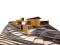 an architectural model of a building with wavy lines on the roof