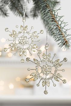 a snowflake ornament hanging from a christmas tree