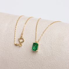 "Emerald; It is considered to be a stone of love, sensitivity and loyalty. It is seen as a symbol of harmony in relationships. Our rectangular emerald necklace, with its minimalist design, is a jewel that you can use daily and on special occasions. It is a nice gift for yourself and your loved ones. The birthstone of those born in May is emerald. 🔸🔸 Our elegant, style and stylish products suitable for special occasions and daily use are produced with love and care for you and your loved ones. Fine Jewelry Rectangular Pendant As Gift, Classic Necklace With Rectangular Stone As Gift, Minimalist Necklace With Rectangular Gemstone, Yellow Gold Necklace With Rectangular Stone For Anniversary, Yellow Gold Emerald Jewelry With Rectangular Stone, Anniversary Jewelry With Rectangular May Birthstone, Fine Jewelry Necklaces With Rectangular Gemstone, Rectangular Emerald Necklace Fine Jewelry, Rectangular Emerald Fine Jewelry Necklace