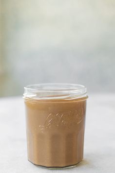 a jar filled with peanut butter sitting on top of a table