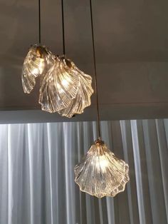 three lights hanging from the ceiling in a room