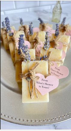 soap bars with lavender flowers tied to them on a plate