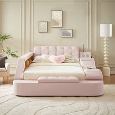 a large pink bed sitting on top of a white rug