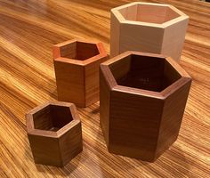 three wooden containers sitting on top of a wooden table