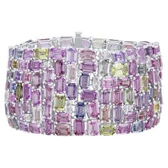 This extravagant, gorgeous bracelet features 119.06 carats emerald cut and oval cut sapphires, including pink, yellow, green, lavender, and light blue. 3.68 carats marquise and round cut natural diamonds are tucked inside the densely packed array. The bracelet measures 7" in length and is set in 18k White Gold. GIA Certification has been obtained on the finished piece. The certificate will be provided with your purchase. (photo included for reference) GIA certification represents one of the high Lavender And Light Blue, Green Lavender, Gem Jewelry, Lovely Lavender, Gold Bracelets, Gemstone Engagement, Marquise Cut Diamond, Expensive Jewelry, Sapphire Bracelet