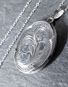 ♥ Welcome to RAVEN FALLS ♥ Celtic, Curios, Cats, Trees & Crows  ✯ VINTAGE LOCKET NECKLACE ✯ ✯ Sterling Silver ✯ This is a vintage silver locket.  It is an oval shape with a delicate and pretty scroll fauna pattern on the front and a rounded border edge. Inside there are the original inserts and it opens and shuts securely.  It is marked for sterling silver on the back and comes suspended on a more modern 18" sterling silver chain.  Please see photos for more details, thanks.  SPECIFICS Approx Me Silver Oval Locket Necklace For Vintage Collection, Antique Oval Sterling Silver Locket Necklace, Vintage Sterling Silver Oval Pendant Locket Necklace, Vintage Sterling Silver Oval Locket Necklace, Silver Oval Locket Necklace Nickel-free, Vintage Locket Necklace, Locket Necklace Silver, Sterling Silver Locket Necklace, Locket Necklace Vintage