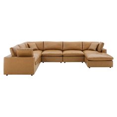 a large sectional couch with pillows on the top and bottom corner, in tan fabric