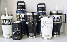 the yeti cups are lined up next to each other on the counter top,