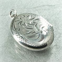 Vintage Sterling silver pendant charm, textured 925 oval floral textured two photos locket, stamped sterling Antique Silver Locket Necklace With Charms, Silver Antique Locket Necklace With Charms, Vintage Silver Locket Necklace With Charms, Silver Vintage Locket Necklace With Charms, Silver Round Pendant Locket Stamped 925, Silver Pendant Locket Necklace Stamped 925, Vintage Silver Flower Pendant Locket Necklace, Silver Locket Necklace With 925 Stamp, Silver Flower Pendant Locket Jewelry