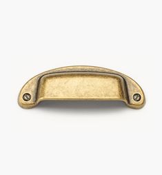 an antique brass cabinet door handle on a white background with clipping for text or image