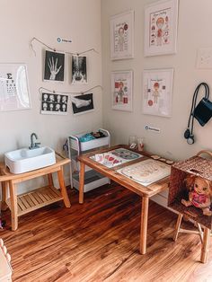 a child's playroom with wooden floors and pictures on the wall above it