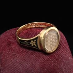 Beautiful Antique Victorian 18K Yellow Gold Enamel Hair Mourning Ring. This amazing ring has pristine enameling and the hair is still intact inside the glass. It has flower designs on the side of the ring without any damage which is rare. The inside of the ring is hallmarked.Item #R0926Metal: 18K Yellow Gold.Weight: 4 GramsRing Size: 8Measurements: Top measures 13 mm wide and band measures 2.8 mm wide.Measurement from finger to top of ring: 3.75  mmLayaway: For your convenience, we will be happy Vintage Gold Enamel Ring Stamped 14k, Antique Enamel Ring Collectible, Black Enamel Ring For Wedding, Antique Black Enamel Signet Ring, Victorian Oval Enamel Ring For Anniversary, Antique Black Enamel Jewelry For Wedding, Victorian Oval Yellow Gold Enamel Ring, Antique Yellow Gold Signet Ring With Black Enamel, Antique Yellow Gold Enamel Wedding Ring