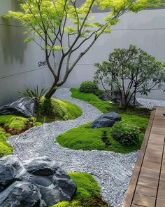 a garden with rocks, grass and trees