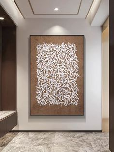 a large white painting hanging on the side of a wall next to a brown and white tiled floor