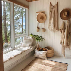 a room with some hats hanging on the wall and a bench in front of it