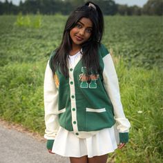 Show your Hawkins High School Pride by getting into uniform with our cozy knit cardigan featuring embroidered chenille patches. Go Tigers! 100% Acrylic Oversized Unisex Fit Embroidered Chenille Patches Stranger Things x Cakeworthy Licensed Product. Model Sizes: Male Model: Medium Female Model: Small White Fall Sweater For College, Fall Collegiate Style College Cardigan, Collegiate Cardigan For College In Fall, White Collegiate Sweater For Fall, Collegiate Fall Cardigan For College, Collegiate Style Cardigan For Fall College Season, Collegiate Style Fall Cardigan For College, Collegiate Long Sleeve Cardigan For College, Long Sleeve Collegiate Cardigan For College